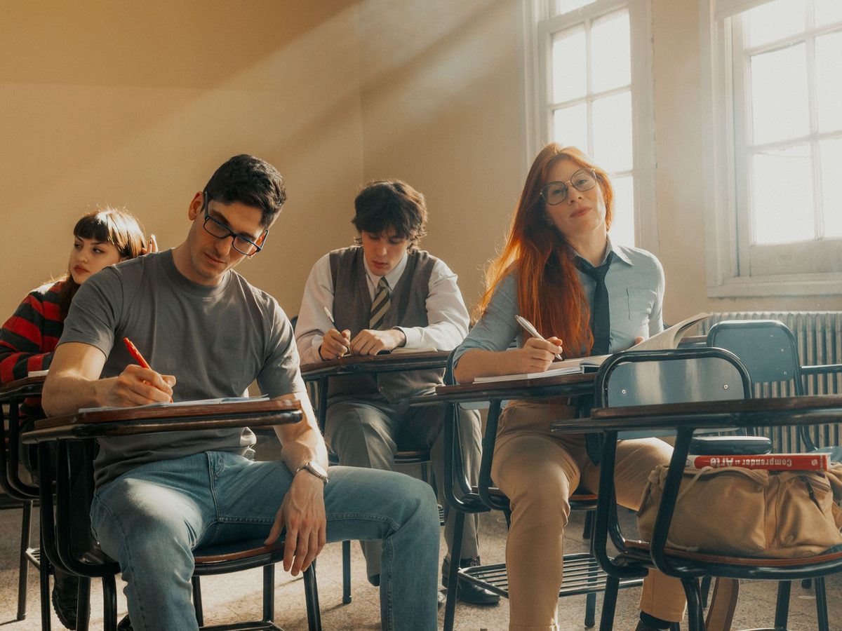 Alumnos adultos escribiendo en un aula